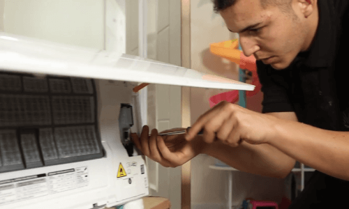 Engineer working on an air conditioning unit